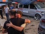 Members of the press mourn following an Israeli strike that reportedly struck a house used by journalists in the Al-Zawayda city near Deir al-Balah, in the central Gaza on October 19, 2025.