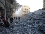 People run for cover following an Israeli strike that targeted a building in the Bureij camp for Palestinian refugees in the central Gaza Strip on October 19, 2025. People run for cover following an Israeli strike that targeted a building in the Bureij camp for Palestinian refugees in the central Gaza Strip on October 19, 2025.