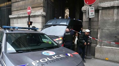 Tourists walk past a French police officer after the Louvre museum was closed following a robbery in Paris. (AFP) Tourists walk past a French police officer after the Louvre museum was closed following a robbery in Paris. (AFP)