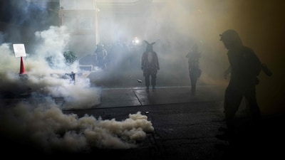 Federal guards throw smoke bombs at anti ICE protestors in Portland on October 18, 2025. (Mathieu Lewis-Rolland/Getty Images via AFP)