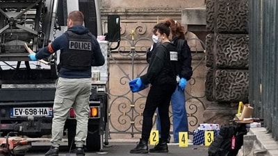 Police officers look for clues by the basket lift used by the thieves to carry out the robbery in Louvre Museum. (AP) Police officers look for clues by the basket lift used by the thieves to carry out the robbery in Louvre Museum. (AP)