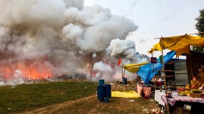 Fatehpur: Dark smoke and flames billow out after a fire broke out at a firecrackers market, in Fatehpur, Uttar Pradesh. (PTI Photo) (PTI) Fatehpur: Dark smoke and flames billow out after a fire broke out at a firecrackers market, in Fatehpur, Uttar Pradesh. (PTI Photo) (PTI)