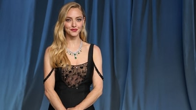 Amanda Seyfried paired her bedazzled black gown featuring a sheer bodice with a stunning diamond necklace adorned with emeralds.&nbsp; (AFP)