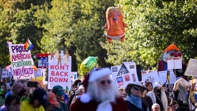 Demonstrators listen to speeches with other protesters during the "No Kings" protest on October 18, 2025 in Portland, Oregon. (Getty Images via AFP) Demonstrators listen to speeches with other protesters during the "No Kings" protest on October 18, 2025 in Portland, Oregon. (Getty Images via AFP)
