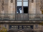 Members of a forensic team inspect a window believed to have been used in what the French Interior Ministry said was a robbery at the Louvre museum during which jewellery was stolen, in Paris, France, October 19, 2025. 