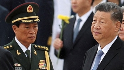 File photo of Central Military Commission Vice Chairman He Weidong walks by Chinese President Xi Jinping. (REUTERS)