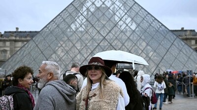 People queue in the Louvre pyramid courtyard moments before the announcement the museum will remain closed for a second day running after thieves stole crown jewels. (AFP) People queue in the Louvre pyramid courtyard moments before the announcement the museum will remain closed for a second day running after thieves stole crown jewels. (AFP)