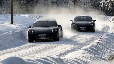 Porsche Taycan driving on a snow-covered road in a winter environment. Porsche Taycan driving on a snow-covered road in a winter environment.