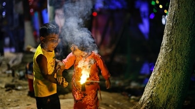 Children play with firecrackers as they celebrate Diwali. (REUTERS)