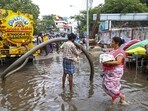 A worker unclogs drain on a waterlogged road following rains, in Chennai on Tuesday. (PTI) A worker unclogs drain on a waterlogged road following rains, in Chennai on Tuesday. (PTI)
