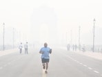 A man Jogs amidst heavy smog at Kartavya Path, in New Delhi on Tuesday. A man Jogs amidst heavy smog at Kartavya Path, in New Delhi on Tuesday.