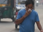 New Delhi: A commuter covers his face while making his way amid low visibility as air quality deteriorates across Delhi-NCR, in New Delhi, Tuesday, Oct. 21, 2025. (PTI Photo/Shahbaz Khan)(PTI10_21_2025_000044B)