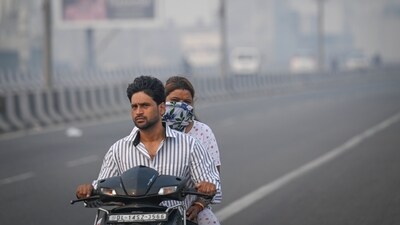 A couple drives near the TV tower in Delhi's Pitampura on Tuesday as AQI in the national capital spiked after Diwali. (Sanchit Khanna/Hindustan Times) A couple drives near the TV tower in Delhi's Pitampura on Tuesday as AQI in the national capital spiked after Diwali. (Sanchit Khanna/Hindustan Times)