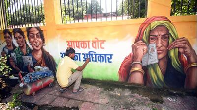 An artist paints a voter awareness mural in Patna, Bihar. (ANI) An artist paints a voter awareness mural in Patna, Bihar. (ANI)