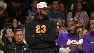 Los Angeles Lakers forward Lebron James (23) looks on from the bench. (IMAGN IMAGES via Reuters Connect)