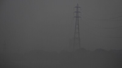 Men walk on the Yamuna riverbed amid heavy smog in New Delhi. (AFP)