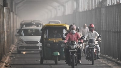 A commuter with his face covered in cloth rides along a bridge across river Yamuna in New Delhi. (AFP) A commuter with his face covered in cloth rides along a bridge across river Yamuna in New Delhi. (AFP)