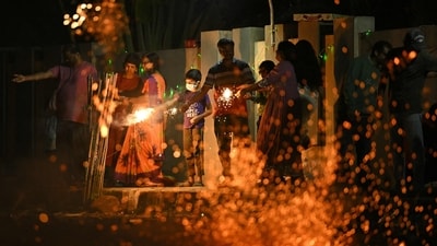 People light firecrackers during the Diwali. (AFP) People light firecrackers during the Diwali. (AFP)
