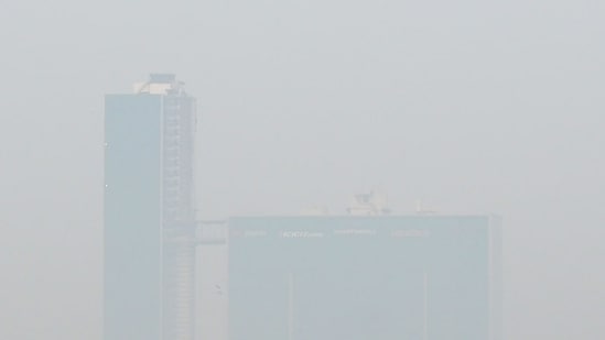View of the skyscraper in Noida amid low visibility due to air pollution early in the morning, a day after Diwali.(Photo by Sunil Ghosh, HT)
