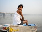 A boy sits on the bank of the Yamuna river amid rising air and water pollution at Kalindi Kunj in New Delhi on Wednesday, October 22, 2025.