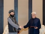 Afghan defence minister, Mullah Mohammad Yaqoob Mujahid and Pakistan's defence minister, Khawaja Muhammad Asif shake hands, following the signing of a ceasefire agreement