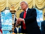US President Donald Trump lights a diya during a Diwali celebration in the Oval Office of the White House on Tuesday, Oct. 21, 2025. US President Donald Trump lights a diya during a Diwali celebration in the Oval Office of the White House on Tuesday, Oct. 21, 2025.