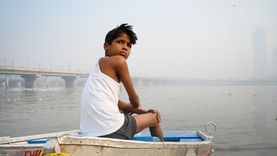 A boy sits on the bank of the Yamuna river amid rising air and water pollution at Kalindi Kunj in New Delhi on Wednesday, October 22, 2025. ( Sunil Ghosh/HT Photo) A boy sits on the bank of the Yamuna river amid rising air and water pollution at Kalindi Kunj in New Delhi on Wednesday, October 22, 2025. ( Sunil Ghosh/HT Photo)