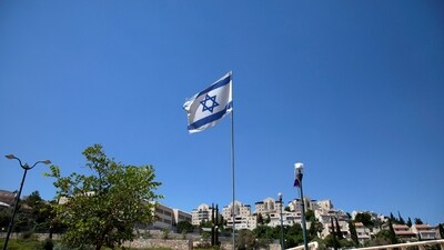 The Israeli national flag flutters as apartments are seen in the background in the Israeli settlement of Maale Adumim in the Israeli-occupied West Bank. (REUTERS File)