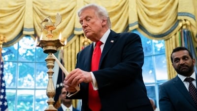 US President Donald Trump lights a diya during a Diwali celebration in the Oval Office of the White House on Tuesday, Oct. 21, 2025. (Bloomberg) US President Donald Trump lights a diya during a Diwali celebration in the Oval Office of the White House on Tuesday, Oct. 21, 2025. (Bloomberg)