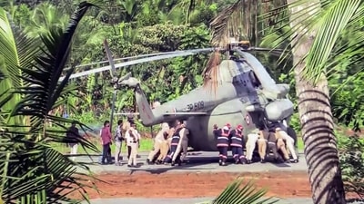 Police and fire department personnel physically push a helicopter as a portion of the helipad tarmac sank in, after a chopper carrying President Droupadi Murmu landed at Pramadam Stadium, in Kerala on Wednesday. (ANI Video Grab) Police and fire department personnel physically push a helicopter as a portion of the helipad tarmac sank in, after a chopper carrying President Droupadi Murmu landed at Pramadam Stadium, in Kerala on Wednesday. (ANI Video Grab)