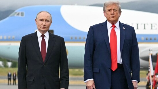 US President Donald Trump (R) and Russian President Vladimir Putin pose on a podium on the tarmac after arrival at Joint Base Elmendorf-Richardson in Anchorage, Alaska, on August 15, 2025. (AFP)