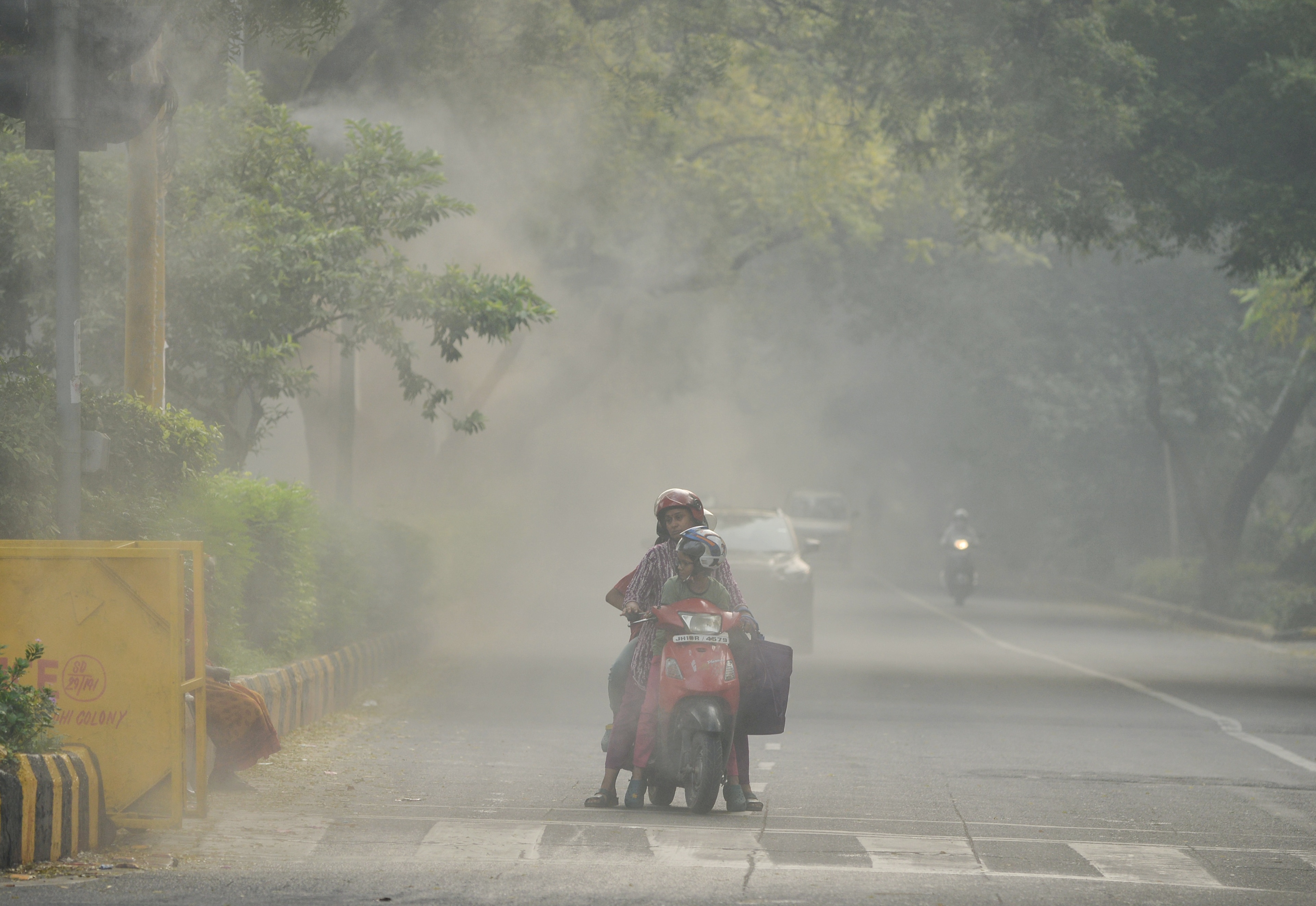 Commuters travel as mist sprayers are installed to control air pollution and suppress dust along Lodhi Road in New Delhi. (Sathiya/ANI Photo) Commuters travel as mist sprayers are installed to control air pollution and suppress dust along Lodhi Road in New Delhi. (Sathiya/ANI Photo)