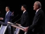 Andrew Cuomo gestures towards Republican candidate Curtis Sliwa and Democratic candidate Assemblyman Zohran Mamdani