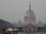 Rashtrapati Bhavan appears shrouded in a thick haze amid low visibility caused by deteriorating air quality in Delhi. (PTI) Rashtrapati Bhavan appears shrouded in a thick haze amid low visibility caused by deteriorating air quality in Delhi. (PTI)
