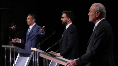 Andrew Cuomo gestures towards Republican candidate Curtis Sliwa and Democratic candidate Assemblyman Zohran Mamdani (via REUTERS)