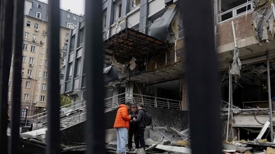 Residents stand near a damaged business centre following a drone attack in Kyiv, on October 23, 2025, amid the Russian invasion of Ukraine. (AFP) Residents stand near a damaged business centre following a drone attack in Kyiv, on October 23, 2025, amid the Russian invasion of Ukraine. (AFP)