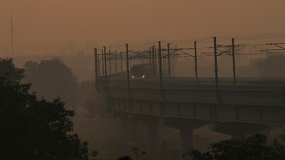 A metro train makes its way on a hazy morning amid low visibility, in New Delhi on October. 23. (PTI) A metro train makes its way on a hazy morning amid low visibility, in New Delhi on October. 23. (PTI)