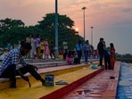 A worker paints a ghat on the banks of the Gomti river during sunset in Lucknow on Friday (PTI) A worker paints a ghat on the banks of the Gomti river during sunset in Lucknow on Friday (PTI)