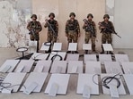 Members of Myanmar's military standing next to Starlink devices seized during a raid on the KK Park online scam centre in Myawaddy.