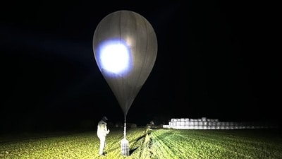 In this undated photo released by the State Border Guard Service, an officer inspects a balloon used to carry cigarettes into Lithuania, because Belarussian smugglers often use them to ferry the contraband into the European Union. (AP) In this undated photo released by the State Border Guard Service, an officer inspects a balloon used to carry cigarettes into Lithuania, because Belarussian smugglers often use them to ferry the contraband into the European Union. (AP)