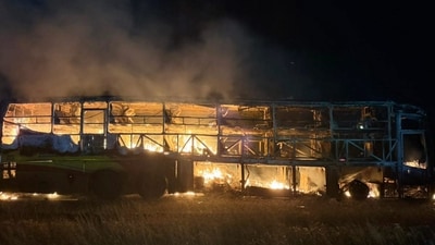 A private bus from Hyderabad-Bengaluru after it caught fire following a collision with a two-wheeler, near Chinnatekur in Kurnool district, Andhra Pradesh, Friday. (PTI) A private bus from Hyderabad-Bengaluru after it caught fire following a collision with a two-wheeler, near Chinnatekur in Kurnool district, Andhra Pradesh, Friday. (PTI)
