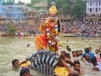 An artiste dressed up as Lord Sri Krishna, jumped on the hood of Kalia Naag in the Ganga (Rajesh Kumar/HT) An artiste dressed up as Lord Sri Krishna, jumped on the hood of Kalia Naag in the Ganga (Rajesh Kumar/HT)