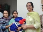 Officials of the Mansa child welfare wing of the state social welfare department with rescued child. (HT)