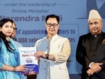 Union minister Kiren Rijiju presents a booklet during the Rozagar Mela Programme at Mata Vaishno Devi University in Katra on Friday. (ANI)