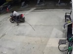 The CCTV video shows the biker losing balance before speeding out of the petrol pump