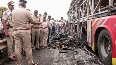 Police personnel investigate the site of a tragic bus fire near Chinna Tekur village in Kurnool on Friday. (ANI Video Grab) Police personnel investigate the site of a tragic bus fire near Chinna Tekur village in Kurnool on Friday. (ANI Video Grab)