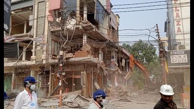 Bulldozers in action at the Central Market in Meerut on Saturday. (HT)