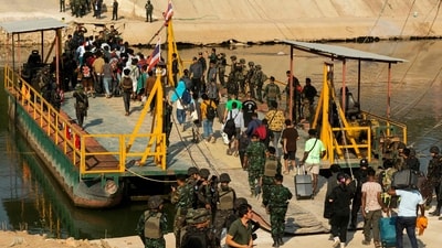Alleged victims of scam centres board a boat to cross the river on the Myanmar-Thai border to be met by Thai Army soldiers as they are repatriated from Kyauk Khet in Myawaddy in Myanmar's Kayin State. (AFP) Alleged victims of scam centres board a boat to cross the river on the Myanmar-Thai border to be met by Thai Army soldiers as they are repatriated from Kyauk Khet in Myawaddy in Myanmar's Kayin State. (AFP)