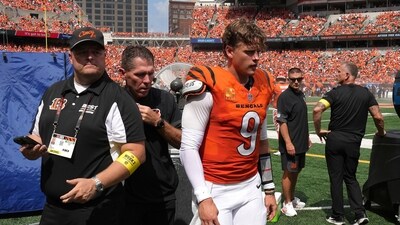 Cincinnati Bengals quarterback Joe Burrow, center, exits the medical tent for the locker room after suffering an injury. (AP) Cincinnati Bengals quarterback Joe Burrow, center, exits the medical tent for the locker room after suffering an injury. (AP)