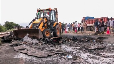 A view of the spot where a bus caught fire following a collision with a two-wheeler near the Chinnatekur village, in Kurnool on Friday. (ANI Video Grab) A view of the spot where a bus caught fire following a collision with a two-wheeler near the Chinnatekur village, in Kurnool on Friday. (ANI Video Grab)